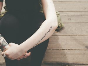 photo of a young woman's tattooed arms