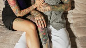 couple with tattoos hugging